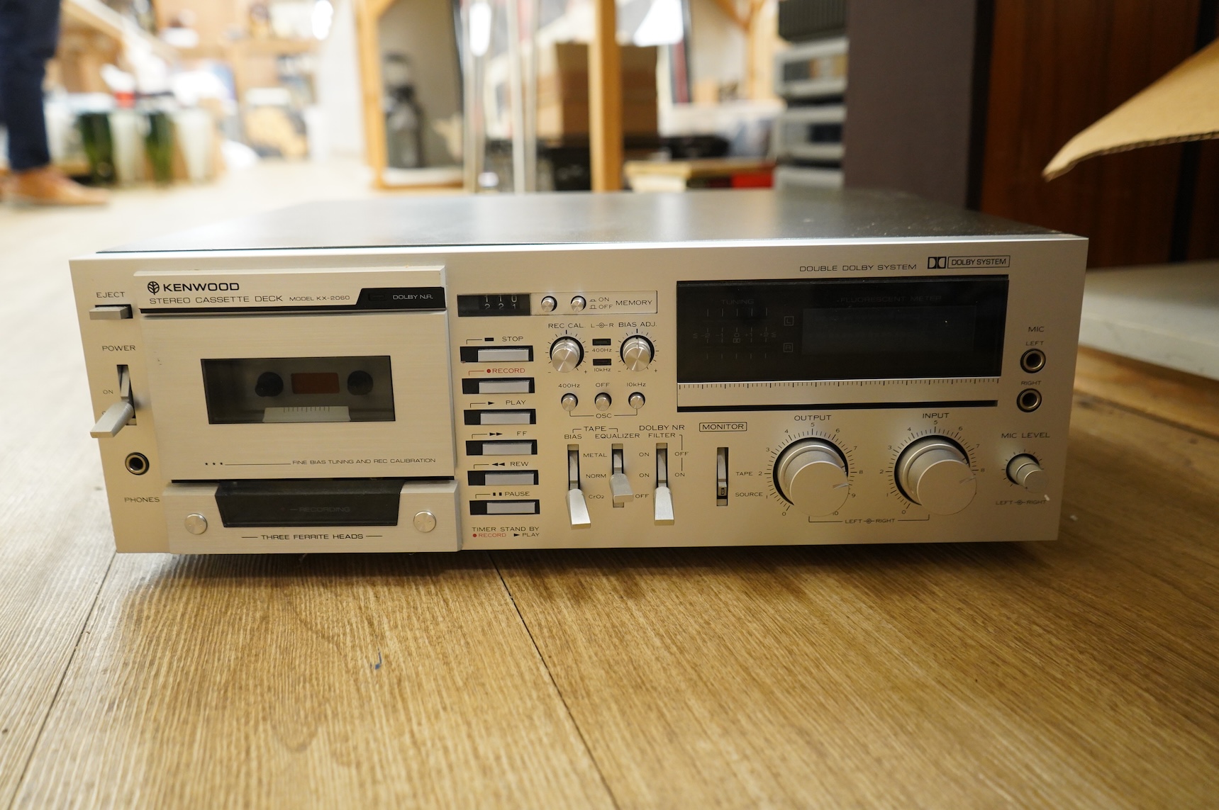 A collection of stereo equipment, including a Project P1 turntable record player, a Denon UPA-F10 integrated stereo amplifier with remote control, a boxed Kenwood KX-260 cassette tape player and a pair of Monitor Audio s